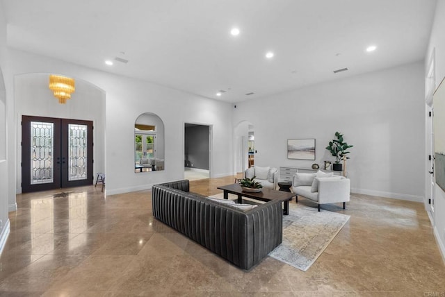 living area with french doors, arched walkways, baseboards, and recessed lighting