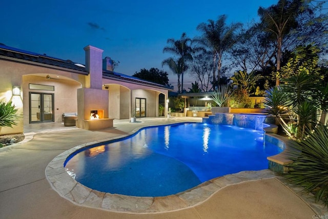 outdoor pool with a patio and french doors