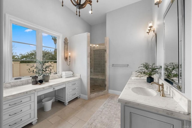 full bathroom with vanity, baseboards, and a stall shower