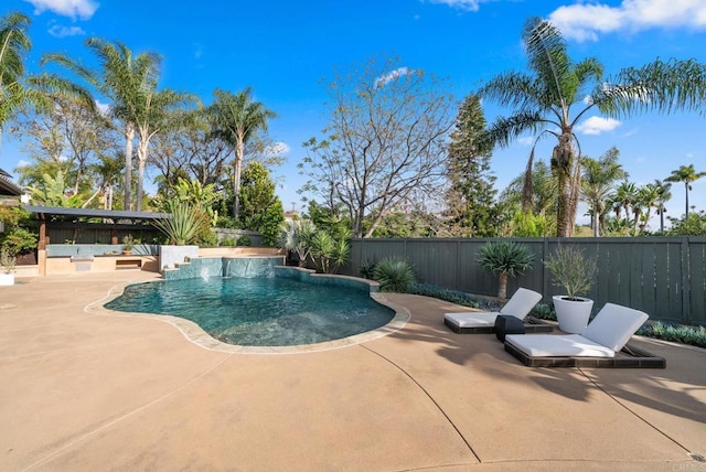 view of swimming pool featuring a fenced in pool, a fenced backyard, and a patio area