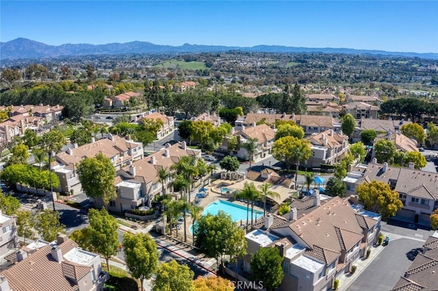 drone / aerial view featuring a residential view and a mountain view