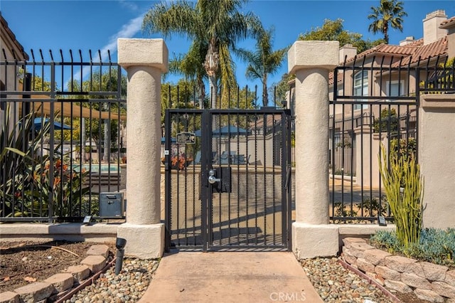 view of gate with fence