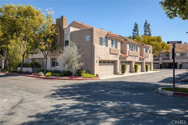 view of property with an attached garage and a residential view