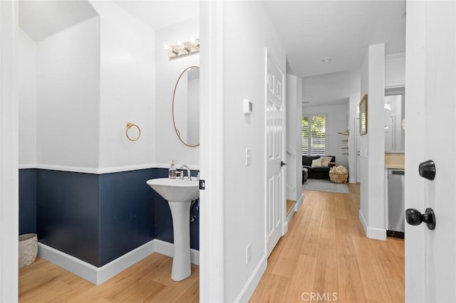 bathroom with wood finished floors and baseboards