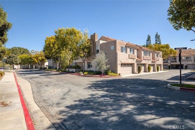 view of road with sidewalks, a residential view, and curbs