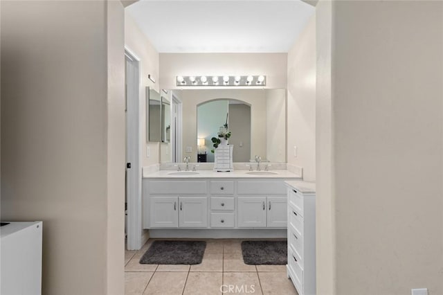 bathroom featuring a sink, double vanity, and tile patterned flooring