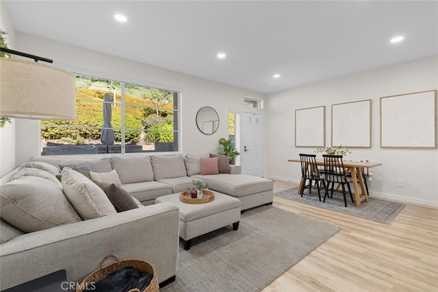 living area featuring recessed lighting, wood finished floors, and baseboards