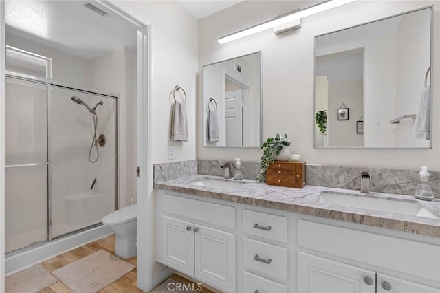 bathroom featuring a sink, visible vents, and a stall shower