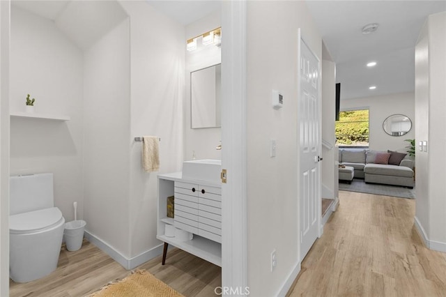 bathroom featuring recessed lighting, toilet, baseboards, and wood finished floors