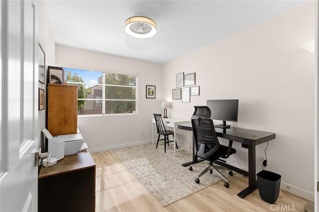 office area with baseboards and wood finished floors