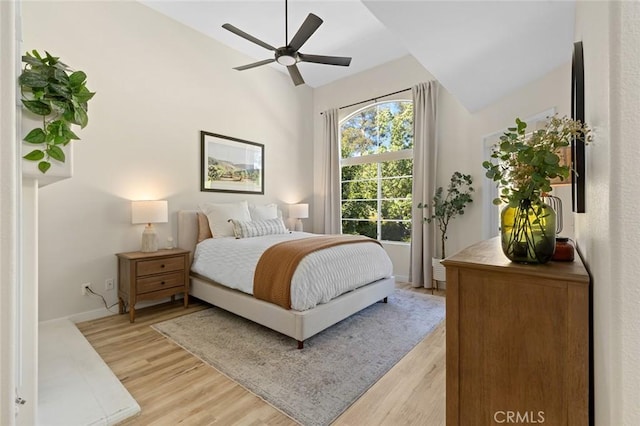 bedroom featuring ceiling fan, baseboards, and light wood-style floors