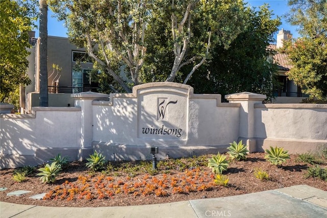 community sign featuring fence