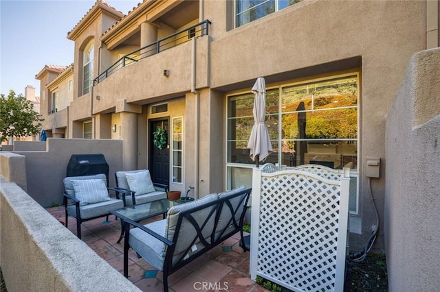 view of patio with a balcony and outdoor lounge area