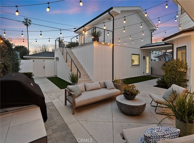 view of patio / terrace with grilling area, an outdoor living space, stairs, and fence