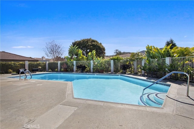 view of swimming pool with a patio area, fence, and a fenced in pool