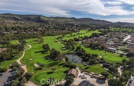 drone / aerial view with a mountain view and golf course view