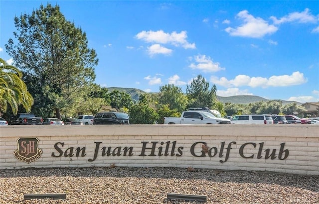 community / neighborhood sign with a mountain view