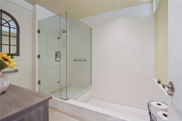 bathroom featuring tile patterned floors and a stall shower