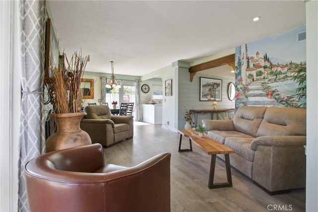 living area featuring recessed lighting, a notable chandelier, wood finished floors, and visible vents