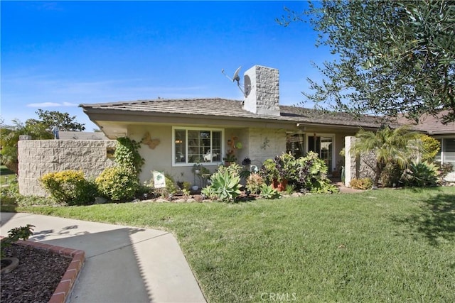 view of front of home featuring a front yard, stucco siding, and a chimney