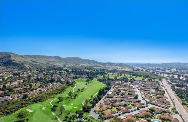 birds eye view of property with a mountain view and view of golf course