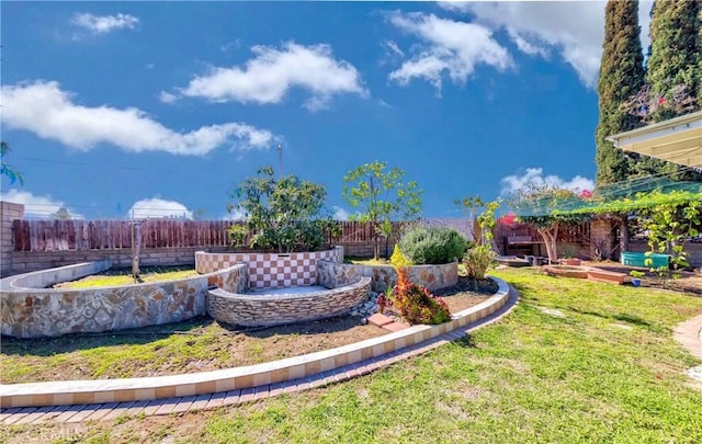 view of yard with a garden and a fenced backyard