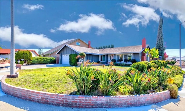 ranch-style home featuring an attached garage, driveway, and a front lawn