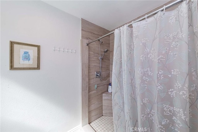 bathroom with tiled shower