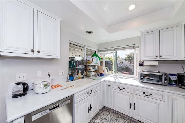 kitchen with appliances with stainless steel finishes, white cabinets, and light countertops