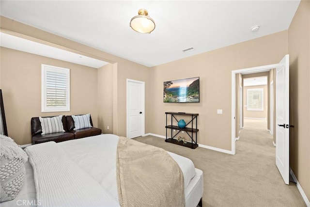 bedroom featuring baseboards, light carpet, and visible vents