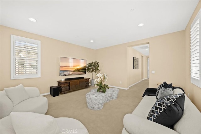 living area with recessed lighting, baseboards, carpet floors, and a healthy amount of sunlight