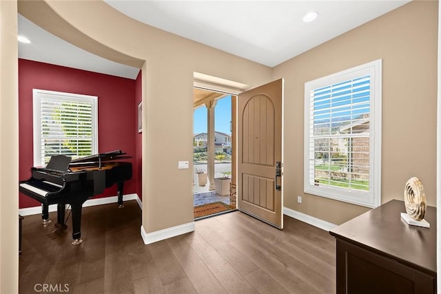 foyer entrance featuring dark wood-type flooring, recessed lighting, and baseboards