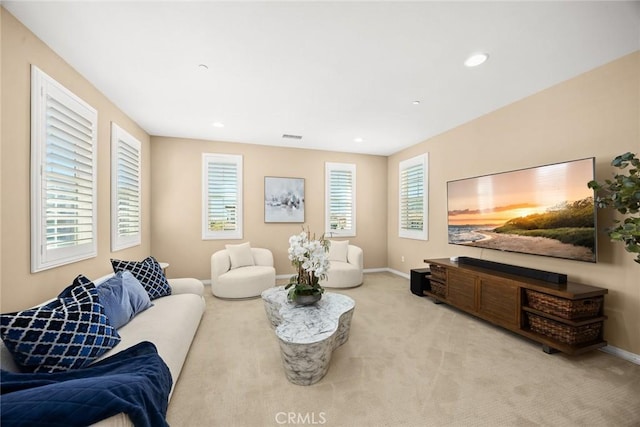 carpeted living room featuring recessed lighting, visible vents, and baseboards