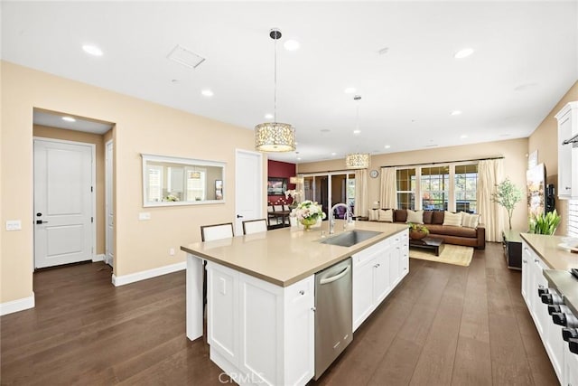 kitchen featuring dark wood finished floors, dishwasher, white cabinetry, and a sink