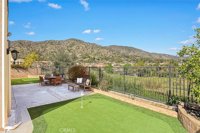 view of yard with a mountain view, a patio, and a fenced backyard