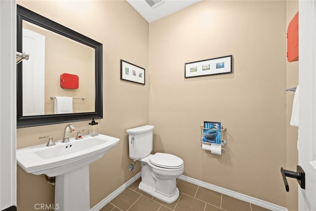 bathroom with visible vents, baseboards, and toilet