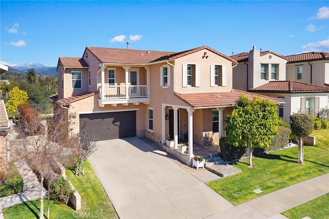 mediterranean / spanish home featuring a tiled roof, stucco siding, an attached garage, and concrete driveway