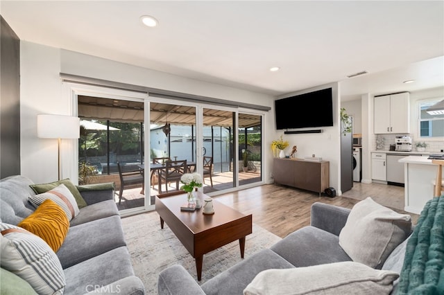 living area featuring recessed lighting, visible vents, and light wood-type flooring