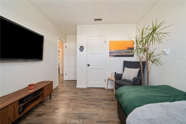 bedroom featuring wood finished floors and baseboards