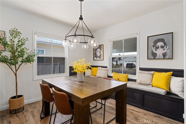 dining room featuring baseboards and wood finished floors