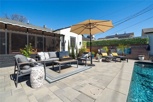 view of patio with an outdoor living space, fence, and a fenced in pool