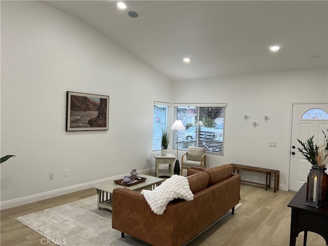 living area with recessed lighting, baseboards, and light wood finished floors