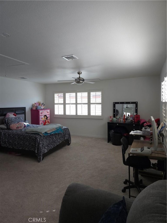 carpeted bedroom with a textured ceiling, visible vents, and ceiling fan