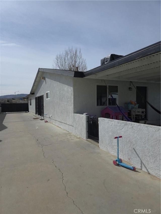 view of home's exterior featuring fence and stucco siding