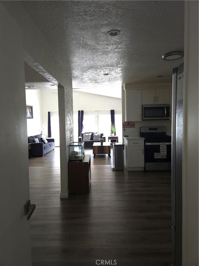 living area with dark wood-style floors and a textured ceiling