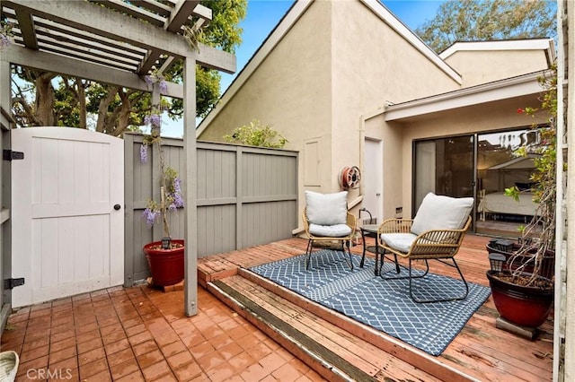 exterior space with a gate, a pergola, and fence