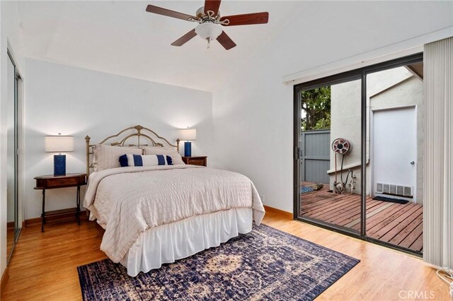 bedroom with visible vents, a ceiling fan, wood finished floors, baseboards, and lofted ceiling