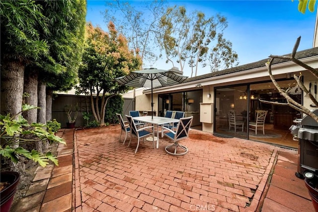 view of patio / terrace featuring outdoor dining area and fence