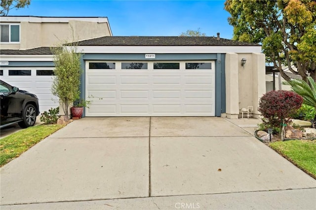 garage featuring concrete driveway