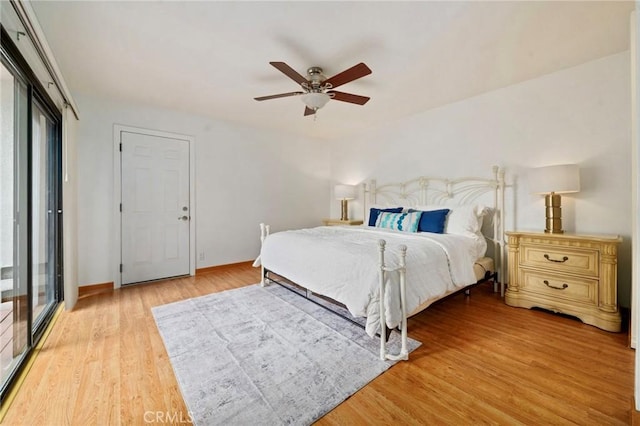 bedroom with light wood-style flooring, multiple windows, baseboards, and ceiling fan